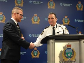 Winnipeg Police Chief Danny Smyth shakes hands with Steven Lang (left), board member of MANTA Swim Club and Operation Red Nose at a media briefing at police headquarters on Friday. Smyth volunteered with Operation Red Nose last Saturday, helping drive home Winnipeggers who have had too much to drink during the holiday season. In its 20th year, Operation Red Nose continues every Friday and Saturday evening plus New Year's Eve. For a donation, volunteers act as designated drivers to get motorists and their vehicles home safely.