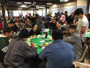 People dig in for Siloam Mission's annual Christmas Eve meal in Winnipeg on Monday. More than 100 volunteers including First Nations and other Manitoba leaders took part in preparing and serving the roughly 800 meals.