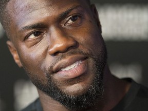 In this Thursday, July 27, 2017, file photo, comedian Kevin Hart speaks to reporters as he arrives on the red carpet for Eat My Shorts at the Short Films Premiere at the Just for Laughs comedy festival in Montreal.