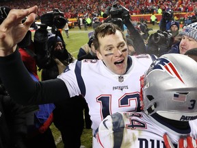 Tom Brady of the New England Patriots celebrates with Rex Burkhead, bottom right, after defeating the Kansas City Chiefs in overtime during the AFC Championship Game at Arrowhead Stadium on Jan. 20, 2019 in Kansas City. (Patrick Smith/Getty Images)