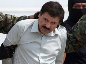 This Feb. 22, 2014 file photo shows Joaquin "El Chapo" Guzman, the head of Mexico's Sinaloa Cartel, being escorted to a helicopter in Mexico City following his capture in the beach resort town of Mazatlan.