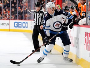 PHILADELPHIA, PENNSYLVANIA - JANUARY 28:   Patrik Laine #29 of the Winnipeg Jets takes the puck in the first period against the Philadelphia Flyers at Wells Fargo Center on January 28, 2019 in Philadelphia, Pennsylvania. (Photo by Elsa/Getty Images)