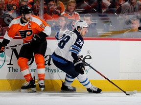 Jack Roslovic of the Winnipeg Jets gets the turnover as Claude Giroux of the Philadelphia Flyers looks on at Wells Fargo Center on Jan. 28, 2019 in Philadelphia