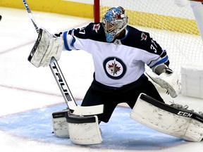 Connor Hellebuyck is back in goal for the Jets when they take on defending Stanle Cup-champion Washington Capitals on Sunday night.