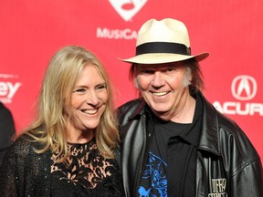 Singer-songwriter Pegi Young, seen here with former husband Neil Young at the Los Angeles Convention Center on Feb. 10, 2012, has died of cancer.