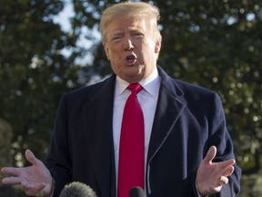 President Donald Trump speaks on the South Lawn of the White House as he walks to Marine One, Sunday, Jan. 6, 2019, in Washington. Trump is en route to Camp David.