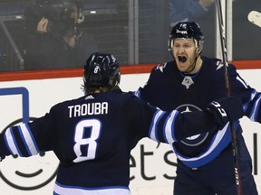 Winnipeg Jets centre Bryan Little (right) celebrates his overtime goal against the Anaheim Ducks in Winnipeg with defenceman Jacob Trouba on Sun., Jan. 13, 2019. Kevin King/Winnipeg Sun/Postmedia Network