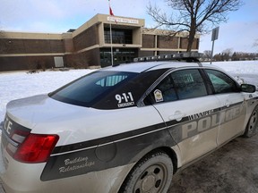 A police car sits outside Arthur Day Middle School on Whitehall Boulevard in Transcona on Monday. The school was placed in a hold-and-secure mode after an apparent online threat. Three schools - including Arthur Day - were the subject of online threats on Friday.