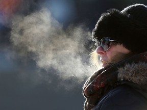 A Winnipegger bundles up in the cold during the Women's March on Saturday.