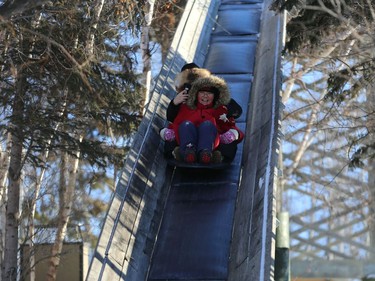 A woman records video as she and a boy ride the giant toboggan slide during Winterfest at Fort Whyte Alive in Winnipeg on Sun., Jan. 20, 2019. Kevin King/Winnipeg Sun/Postmedia Network