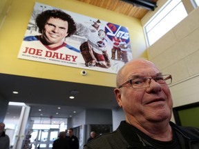 Winnipeg Jets alumnus Joe Daley poses with a mural that was unveiled at Bronx Park Community Centre in Winnipeg on Sunday.