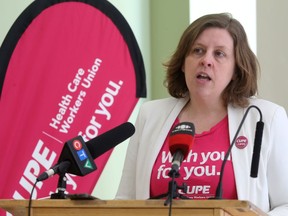 Elizabeth Carlyle, of CUPE, speaking to media in Winnipeg Friday. CUPE is accusing MGEU of fear mongering and making untrue statements about the impact of government policy regarding health care workers.