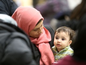 Salwa Al Ibrahim with her son Abdul Kareem Ali at the Newcomer Community Hub at Ryerson School, in Winnipeg Saturday during the official opening.