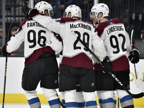 Colorado Avalanche forwards Mikko Rantanen (96), Nathan MacKinnon (29) and Gabriel Landeskog celebrate a goal against the Vegas Golden Knights Thursday, Dec. 27, 2018, in Las Vegas. (AP Photo/David Becker)