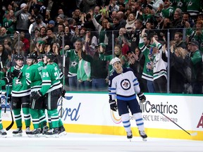 The Stars celebrate a Radek Faksa goal as Jets’ Jack Roslovic looks on Saturday night in Dallas. (GETTY IMAGES)