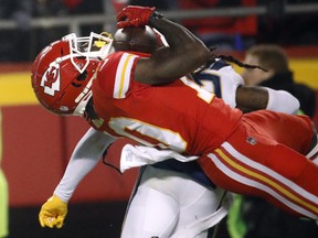 Kansas City Chiefs wide receiver Tyreek Hill (10) is hit by Los Angeles Chargers safety Jahleel Addae (37) while making a catch during the second half of an NFL game in Kansas City, Mo., Thursday, Dec. 13, 2018. (AP PHOTO)