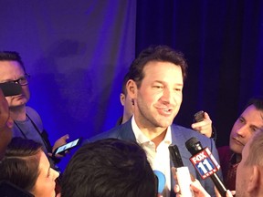 Tony Romo answers questions from reporters during a media scrum on Tuesday. (Don Brennan/Postmedia Network)