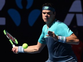 Canada's Milos Raonic hits a return to France's Pierre-Hugues Herbert during their men's singles match at the Australian Open in Melbourne on Saturday, Jan. 19, 2019.