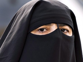 A woman wears a niqab as she walks in Montreal on September 9, 2013. (THE CANADIAN PRESS/Ryan Remiorz)