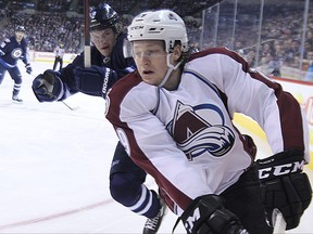 Jets defenceman Jacob Touba (left) will be counted on to help shut down Colorado Avalanche forward Nathan MacKinnon (29) and his high-scoring linemates.
