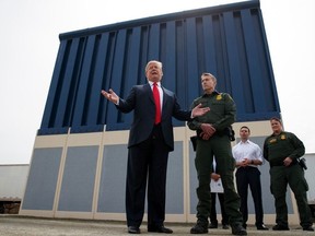 In this March 13, 2018, file photo, President Donald Trump talks with reporters as he reviews border wall prototypes in San Diego. (AP Photo/Evan Vucci, file)