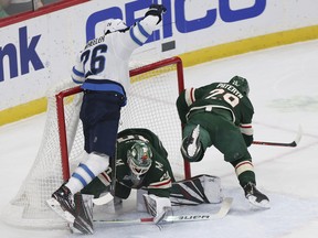 Winnipeg Jets' Blake Wheeler crashes into Minnesota Wild's goalie Devan Dubnyk after trying to score a goal in the first period of an NHL hockey game Thursday in St. Paul, Minn. (AP)