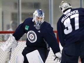 Winnipeg Jets goaltenders Laurent Brossoit (left) and Connor Hellebuyck horse around during an informal workout at Bell MTS Iceplex in Winnipeg on Mon., Sept. 10, 2018.