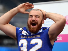 Winnipeg Blue Bombers fullback John Rush reacts to his newly shorn head during Fan Appreciation Day at Investors Group Field in Winnipeg on Sun., Sept. 16, 2018. Rush, who had been growing his hair for five years, had it cut to raise money for the Canadian Cancer Society, a cause near and dear to him after his mother was diagnosed with breast cancer when he was nine. Rush had raised over $3,500 going into the day, with that total expected to rise. Kevin King/Winnipeg Sun/Postmedia Network