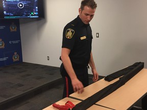 Winnipeg Police Service spokesperson Const. Jay Murray shows off a tire deflation device or Stop Stick at a media briefing on Sunday, Jan. 6, 2019. On Thursday afternoon, a Stop Stick tire-deflation device was deployed at Logan Avenue and King Street but a stolen vehicle drove over the device and continued travelling onto Main Street, where it sideswiped a truck and drove into oncoming traffic. The vehicle continued driving to the intersection of Alfred Avenue and Charles Street, where the driver and lone occupant abandoned the SUV and fled on foot before forcing his way into a house in the 300 block of Alfred Avenue, where children were present.