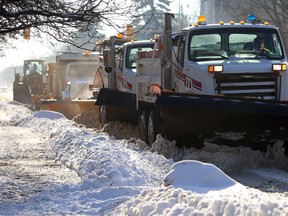 Plows are queued up on Stafford Street in Winnipeg on Monday. The Residential Parking Ban has been lifted, the City of Winnipeg announced Friday.