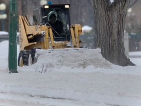 A machine clears a sidewalk after a snowfall. Chris Procaylo/Winnipeg Sun file