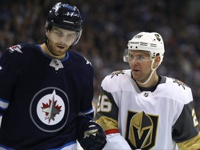 Vegas Golden Knights centre Paul Stastny (right) reacts after being bumped by Winnipeg Jets centre Adam Lowry during a break in play in Winnipeg on Tues., Jan. 15, 2019. Kevin King/Winnipeg Sun/Postmedia Network