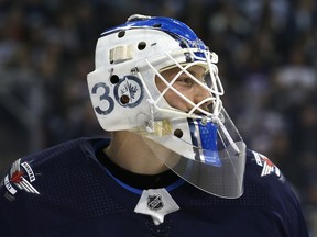 Winnipeg Jets goaltender Laurent Brossoit stays loose during a break in action against the Vegas Golden Knights in Winnipeg on Tues., Jan. 15, 2019. Kevin King/Winnipeg Sun/Postmedia Network