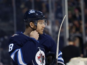 Winnipeg Jets centre Bryan Little straps up his helmet as he readies for his 800th NHL game, against the Vegas Golden Knights in Winnipeg, on Tues., Jan. 15, 2019. Kevin King/Winnipeg Sun/Postmedia Network