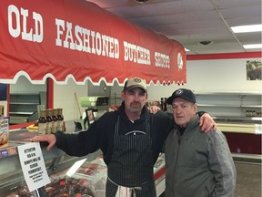 Owner Dennis Dueck (right) and his son Mark stand inside Denny's Meat Market, a local Winnipeg institution which is closing its doors for good on Friday, Feb. 8.