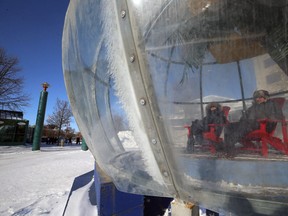 Karin and Rob, last names withheld by request, relax in the Greetings From Bubble Beach warming hut/snow globe at The Forks in Winnipeg on Wed., Jan. 30, 2019. Kevin King/Winnipeg Sun/Postmedia Network