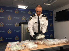 Insp. Max Waddell of the Winnipeg Police Service's Organized Crime unit, holds a package of methamphetamine seized during one of three drug busts carried out by the Winnipeg Police's Drug Enforcement Unit and Street Crime Unit over the past 50 days at a press conference at Winnipeg Police Headquarters on Friday. Winnipeg police announced they had taken over 10 kilograms of methamphetamine worth in excess of $1 million and other drugs off the street following a trio of drug busts in November, December and early January.