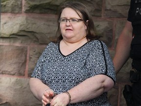 Elizabeth Wettlaufer is escorted by police from the courthouse in Woodstock, Ont, Monday, June 26, 2017. THE CANADIAN PRESS/Dave Chidley
