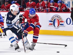 Jack Roslovic (28) of the Winnipeg Jets and Tomas Tatar (90) of the Montreal Canadiens skate after the puck during the NHL game at the Bell Centre on Feb. 7, 2019 in Montreal.
