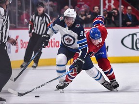 Andrew Copp #9 of the Winnipeg Jets and Nicolas Deslauriers #20 of the Montreal Canadiens skate after the puck during the NHL game at the Bell Centre on February 7, 2019 in Montreal.  (Photo by Minas Panagiotakis/Getty Images)
