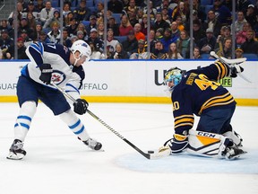 BUFFALO, NY - FEBRUARY 10: Carter Hutton #40 of the Buffalo Sabres makes the save against Adam Lowry #17 of the Winnipeg Jets during the first period at KeyBank Center on February 10, 2019 in Buffalo, New York. (Photo by Kevin Hoffman/Getty Images)