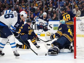 BUFFALO, NY - FEBRUARY 10: Blake Wheeler #26 of the Winnipeg Jets scores the winning goal against Carter Hutton #40 of the Buffalo Sabres as Rasmus Dahlin #26 looks on during the third period at KeyBank Center on February 10, 2019 in Buffalo, New York. (Photo by Kevin Hoffman/Getty Images)