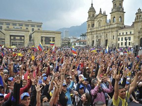 Venezuelan opposition supporters living in Colombia take part in a demonstration to back Venezuelan opposition leader Juan Guaido's calls for early elections, at Plaza de Bolivar square in Bogota, on Feb. 2, 2019.