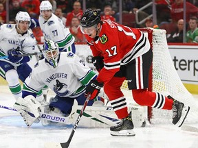 Dylan Strome of the Chicago Blackhawks tries to get off a shot against Jacob Markstrom #25 of the Vancouver Canucks at the United Center on Feb. 7, 2019 in Chicago.