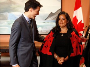 Newly appointed Canadian Veterans Affairs Minister Jody Wilson-Raybould poses for a photo with Prime Minister Justin Trudeau as he shuffles his cabinet after the surprise resignation of Treasury Board President Scott Brison, in Ottawa, Ontario, Canada, January 14, 2019.