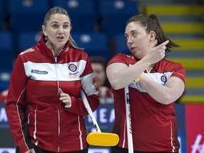 Newfoundland and Labrador skip Kelli Sharpe (left) and third Stephanie Guzzwell chat as they play the Yukon team at the Scotties Tournament of Hearts at Centre 200 in Sydney, N.S. on Sunday.