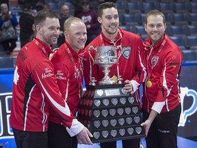 Team Canada skip Brad Gushue, third Mark Nichols, second Brett Gallant and lead Geoff Walker, left to right, pose with the Brier Tankard at the Brandt Centre in Regina on Sunday, March 11, 2018. (THE CANADIAN PRESS/Andrew Vaughan)