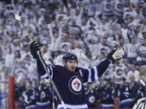 Winnipeg Jets' Mark Scheifele (55) celebrates his goal against the Minnesota Wild during second period NHL game one playoff action in Winnipeg on Wednesday, April 11, 2018. THE CANADIAN PRESS/John Woods ORG XMIT: JGW121