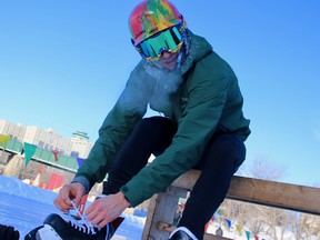 A participant in the inaugural 1JustCity Beat the Cold Winter Triathlon ties his skates for the final leg of the race at The Forks on Sunday, Feb. 17, 2019.