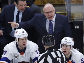 New York Islanders head coach Barry Trotz argues a call with referee Mike Leggo (3) during third period of an NHL hockey game against the Boston Bruins in Boston, Tuesday, Feb. 5, 2019. The Bruins won 3-1.